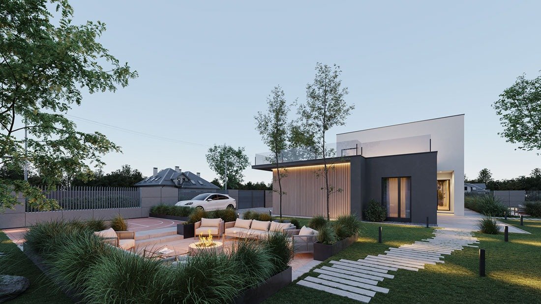 Ngôi nhà hiện đại với vườn xanh và khu vực tiếp khách ngoài trời, cảnh hoàng hôn tạo không gian thư giãn.