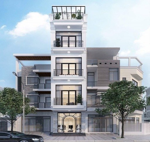 Tòa nhà 5 tầng hiện đại với ban công kính và mặt tiền sang trọng, nổi bật giữa thành phố xanh.