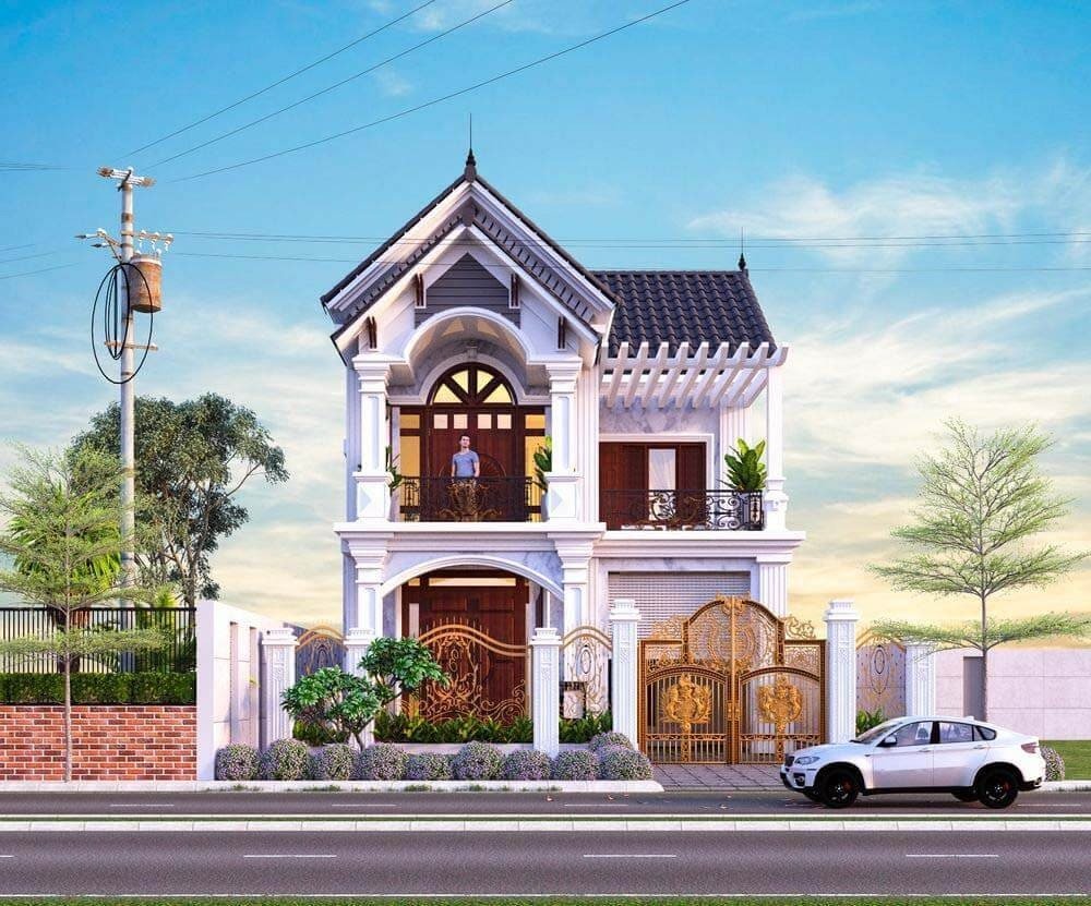 Nhà phố 2 tầng với mái ngói và cửa cổng sang trọng, có xe hơi trắng đỗ bên ngoài, trời xanh nắng đẹp.