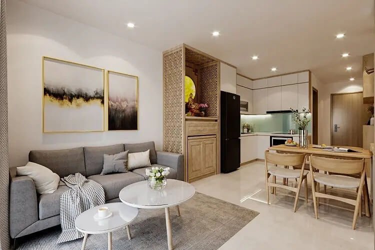 Phòng khách căn hộ hiện đại với sofa xám, bàn trà tròn và bếp mở, thiết kế nội thất tinh tế và ấm cúng.